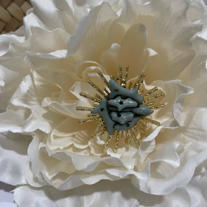 Broche Sol empolvado